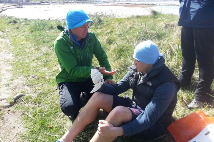 a group of people practicing first aid