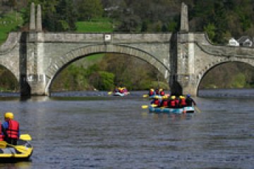 rafts going under a bridge