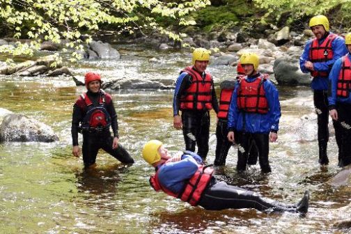 a group of people at a river