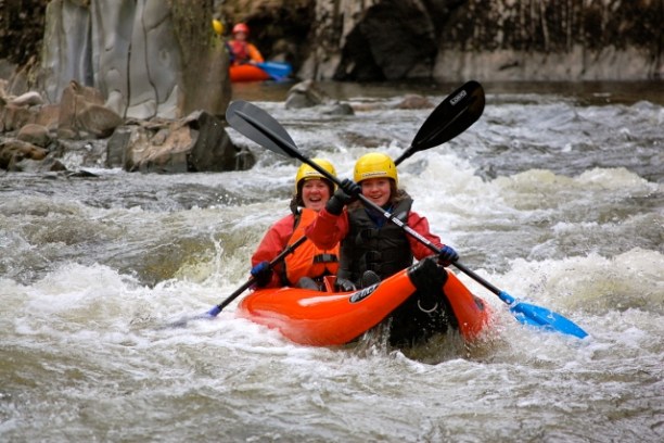 two kayakers on a river in moray
