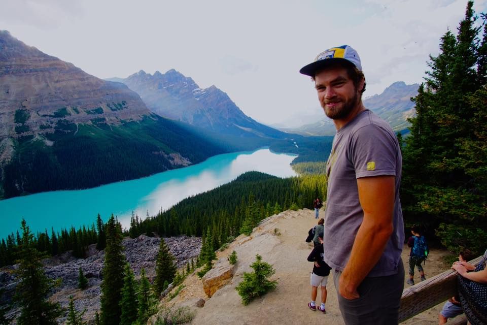 85701cb2b69e9a9f5c7503214df39011 a man standing in front of a mountain