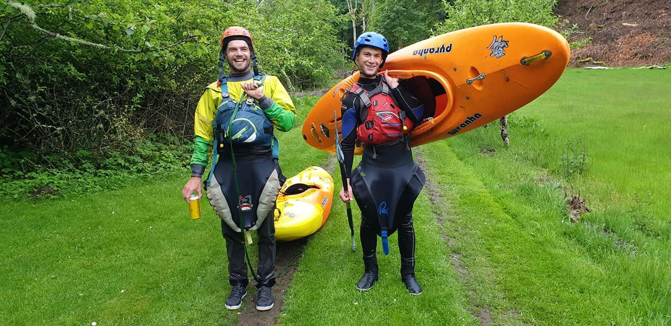 a3841c960582e19b92aedaad526e367a two men carrying kayaks