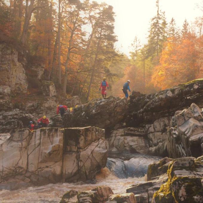a group of people in a canyon in autumn